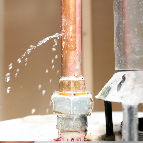 Edison NJ Plumbing - Close-up of a plumber fixing a leaky pipe under a sink